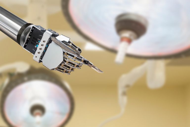 Artificial intelligence and the law: Robotic hand holds a scalpel.