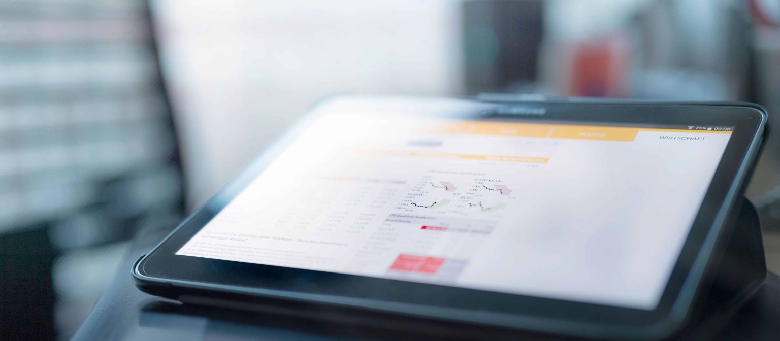 What blockchain contributes to know your customer: Tablet with charts.