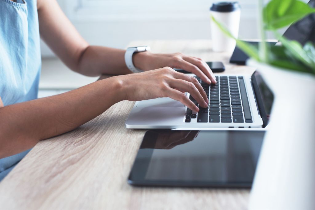 Hands of a businesswoman typing on a laptop