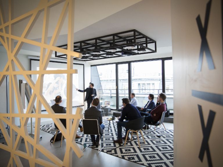 Why EOS is not a startup – but is still agile: A group of people at a meeting.