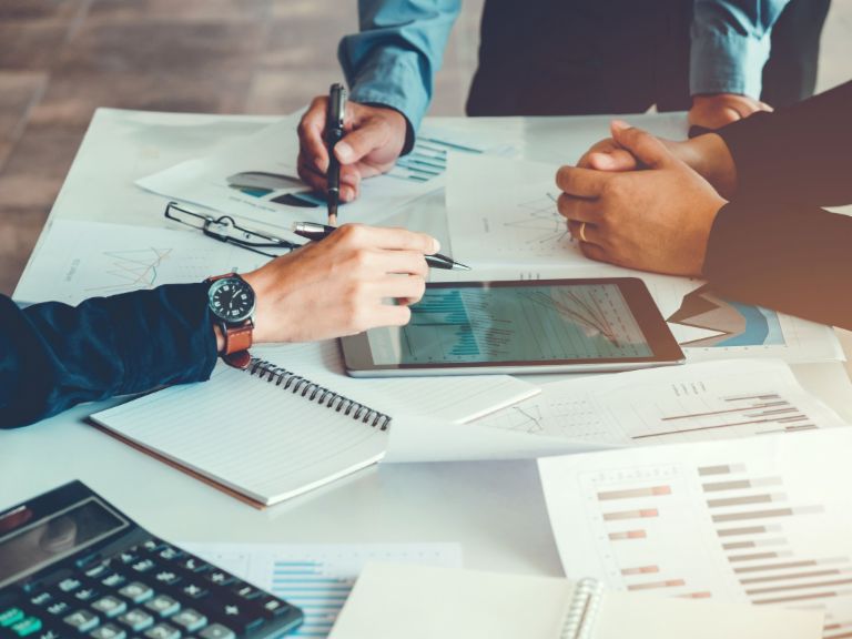 Robotic process automation: People with documents at a desk.
