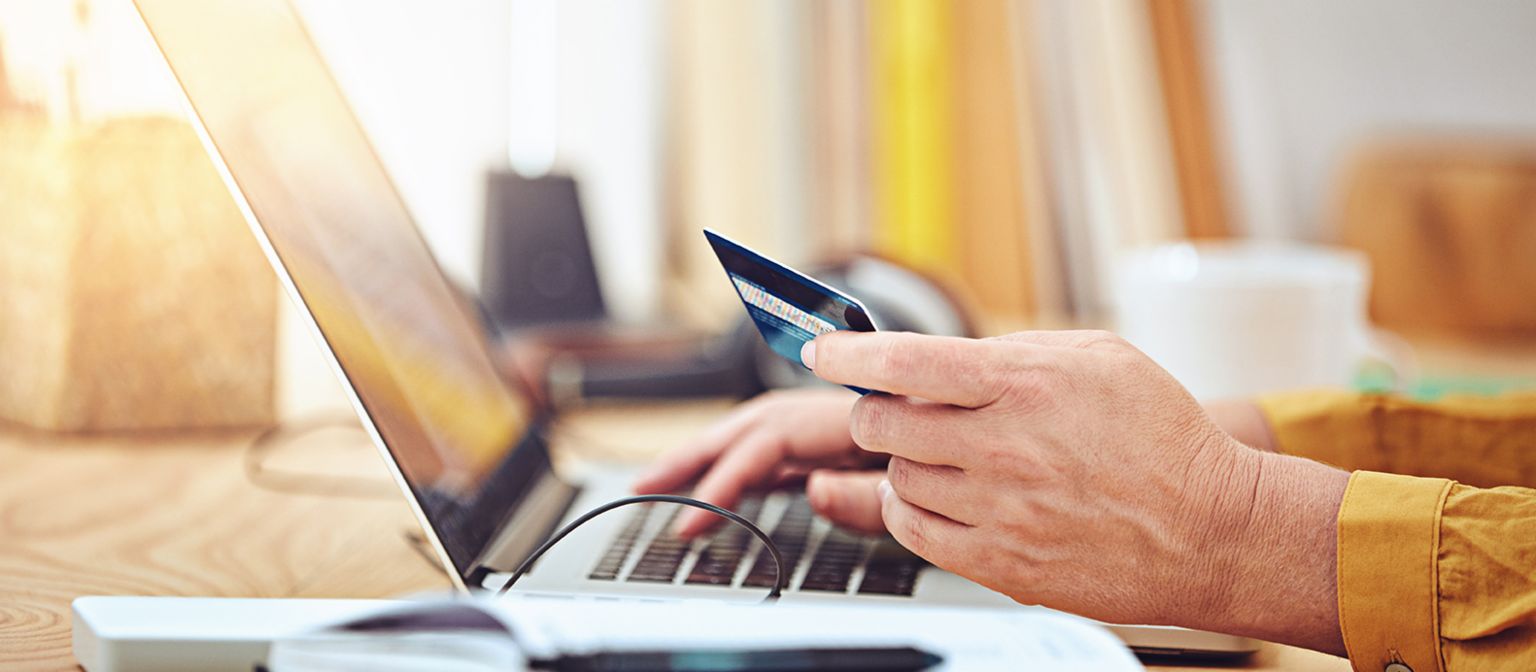 Credit scoring in the online retail segment: Completing an online purchase on a laptop.