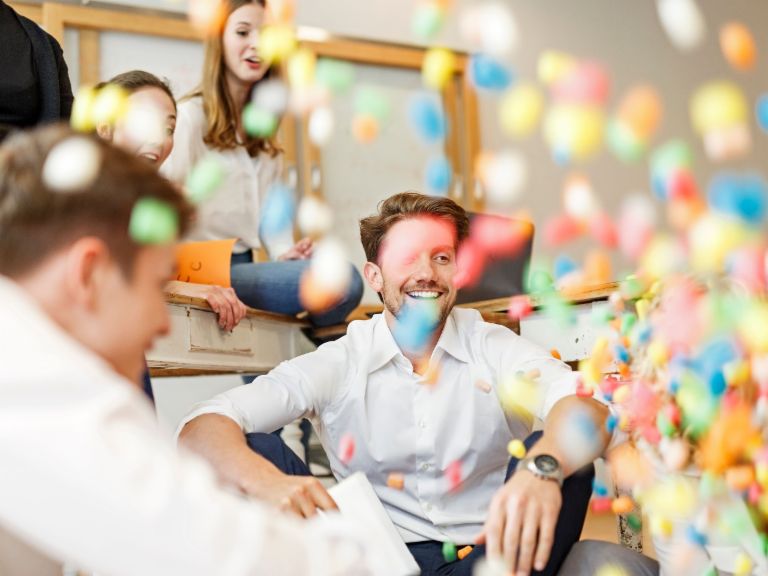 Agile working: Group of employees with lots of colored balls.